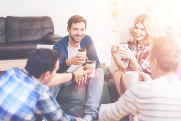 Positive friends drinking coffee