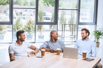 multicultural business people discussing business strategy at meeting in office