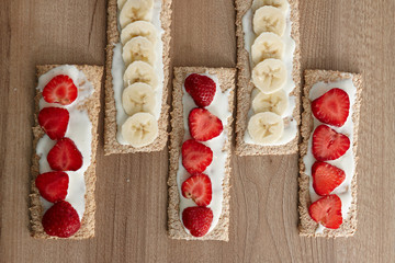 Fruit dessert. Fruits sliced on bread (cookies). View from above. Baban, strawberry. Healthy food.