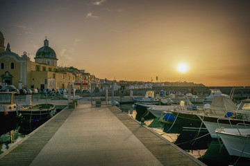 Idyllic view of a yacht marina and mole in the sunset.