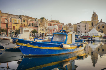 Idyllic view of a yacht marina and blue old boat in foreground.