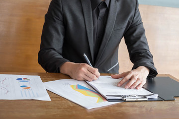 Working process startup. Businessman working at the wood table.
