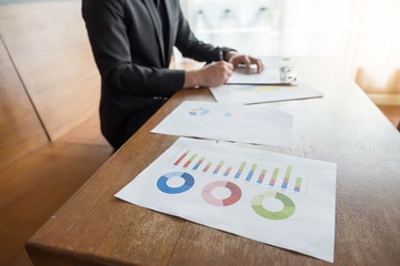 Businessman writing a book at work.