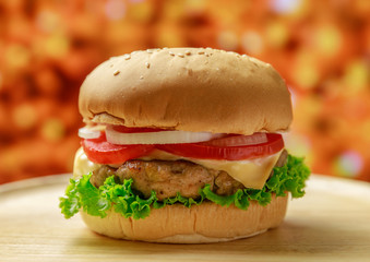 Burger on wooden plate with french fries