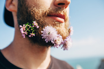 Flowers in the beard of a handsome man