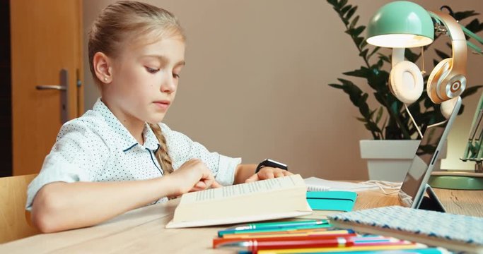 Student girl 8 aged falling asleep when reading textbook