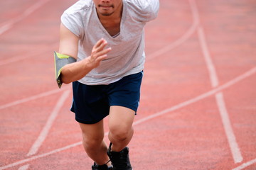 Runner athelete man running on the trackrace . Jogging for healthy concept