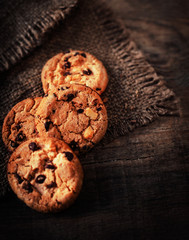 Fresh Chocolate chip cookies on dark old wooden table with place for text.,  freshly baked. Selective Focus with Copy space.