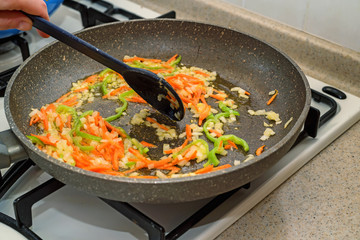 Roasting chopped vegetables on frying pan