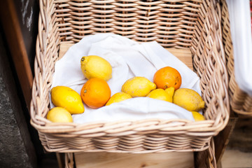 Ripe lemons  in a basket  on a market stall close up image