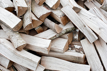 Chopped firewood from a birch background
