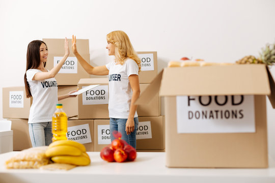 Sincere positive woman giving her colleague a high five