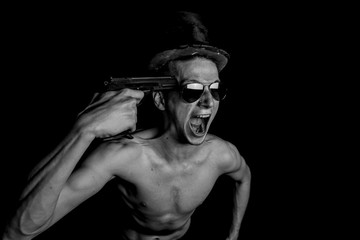 Obraz na płótnie Canvas Crazy Guy Aiming A Gun To His Head