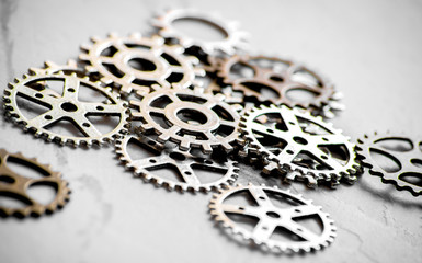 concept hour metal gears on gray background top view