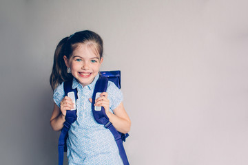 portrait of a smiling schoolgirl in uniform with school backpack, school bag, 1 september back to...