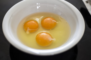 Eggs in white bowl close up top view