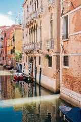 View on a venetian canal with ancient buildings and bridge in Venice