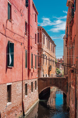 View on a venetian canal with ancient buildings and bridge in Venice