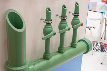 Green plastic water pipes installation with valves