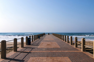 Paved Patterned Pier Extending Out into Ocean