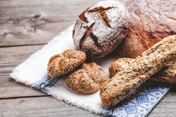 Delicious fresh bread on wooden background