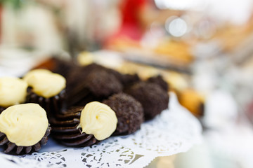 Group of typical churros on a paper tray with chocolate and vanilla filling