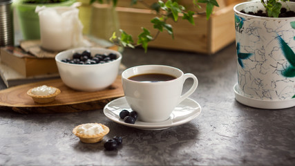 Fototapeta na wymiar Cup of coffee and sweet cakes with berries. Morning breakfast concept