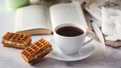 fresh breakfast with hot coffee and book in morning sunlight
