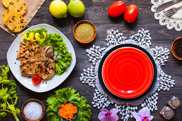 Fototapeta na wymiar Pork steak homemade cooking with spices leaves lettuce on wooden cutting board, and a dish,