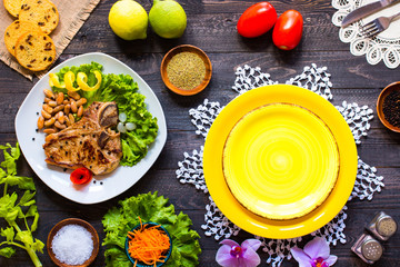 Fototapeta na wymiar Pork steak homemade cooking with spices leaves lettuce on wooden cutting board, and a dish,