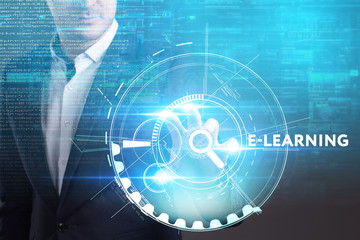 Business, Technology, Internet and network concept. Young businessman working on a virtual screen of the future and sees the inscription: E-learning