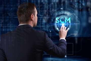 Business, Technology, Internet and network concept. Young businessman working on a virtual screen of the future and sees the inscription: SCM