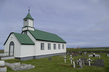 church with green roof at gardur iceland