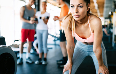 Close up image of attractive fit woman in gym