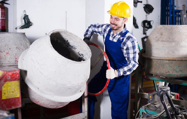 Worker work with cement mixer