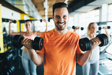 Group of friends exercising together in gym