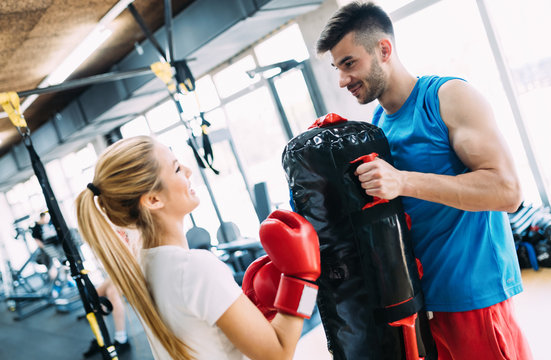 Picture of woman wearing boxing gloves and her trainer