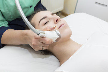 The procedure of lipomassage in a beauty salon makes a woman 