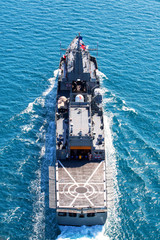 Grey modern warship sailing in the sea
