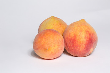 3 ripe peaches isolated on white