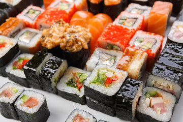 Set of sushi, maki and rolls on white background