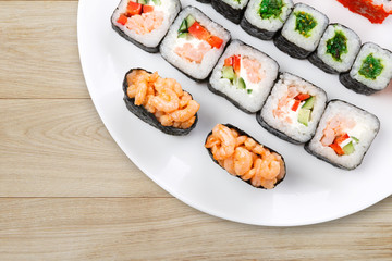 Fototapeta na wymiar Colorful set of sushi and rolls top view on wood, closeup