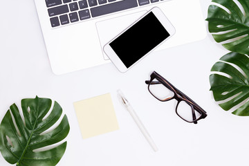 White office desk table with a lot of things on it. Top view with copy space.