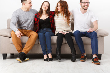 Happy young friends, casual people sitting on couch