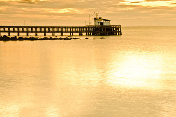 Fototapeta na wymiar silhouette fishing pier,have sea space on foreground,use for background.