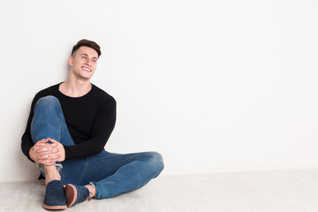 Smiling young man portrait at white studio background.