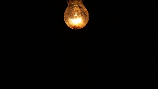 Electric light bulb on a black background