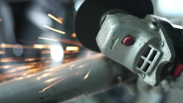 the mechanic works with metal sparks.