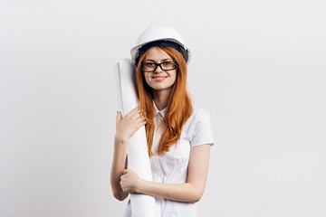 Young beautiful woman on white isolated background holds blueprints