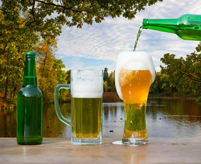 Pouring glass of beer from bottle